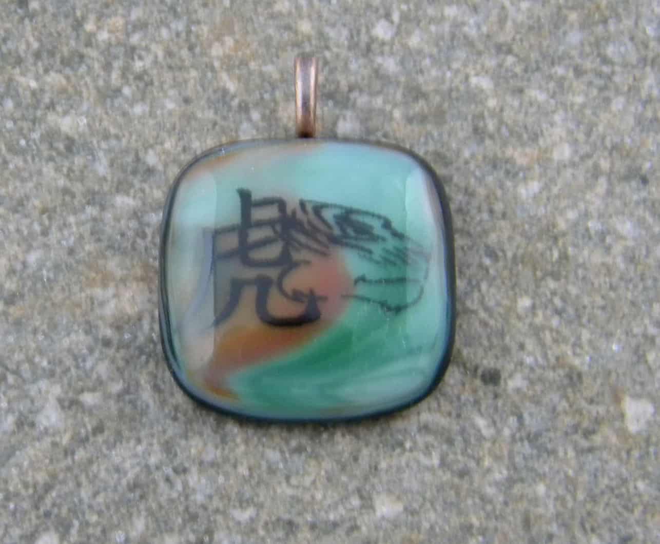 Fused Glass Pendant - Green and orange streaky glass with the Tiger Chinese Zodiac